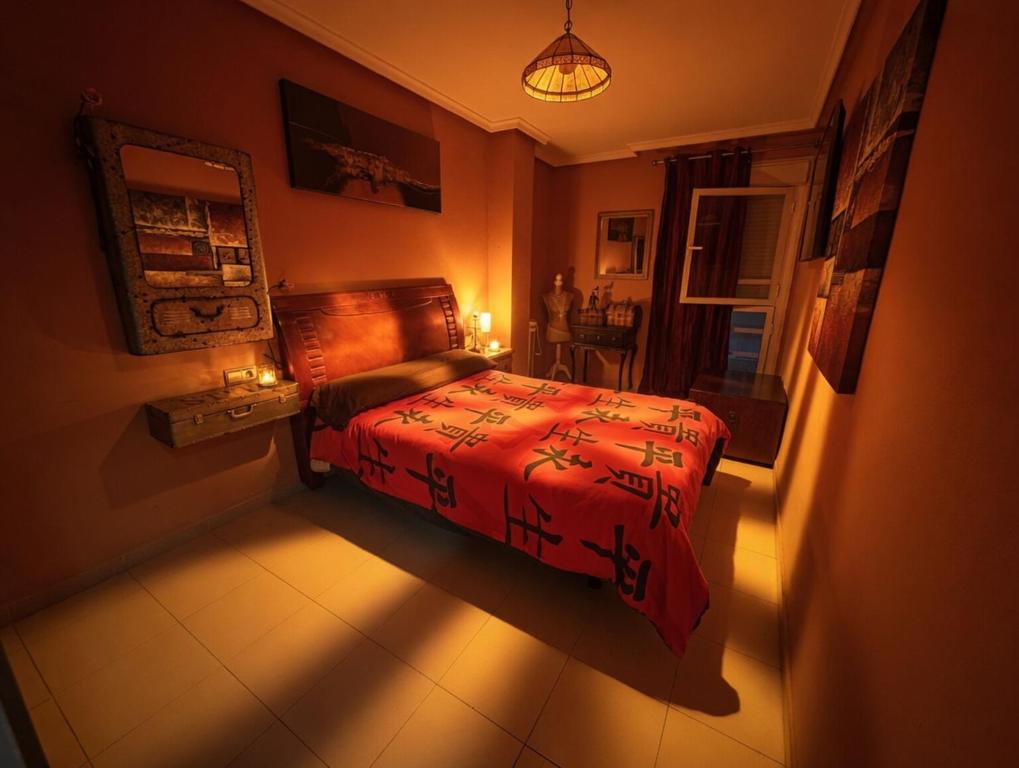 a bedroom with a bed in a room with a window at Paseo del mar in Melilla