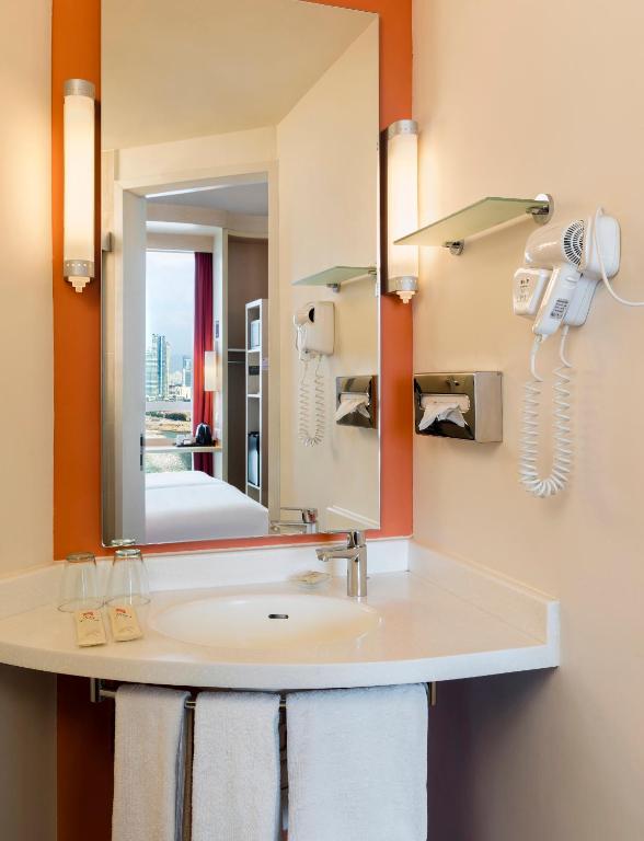 a bathroom with a sink and a mirror at Ibis Hong Kong Central & Sheung Wan in Hong Kong
