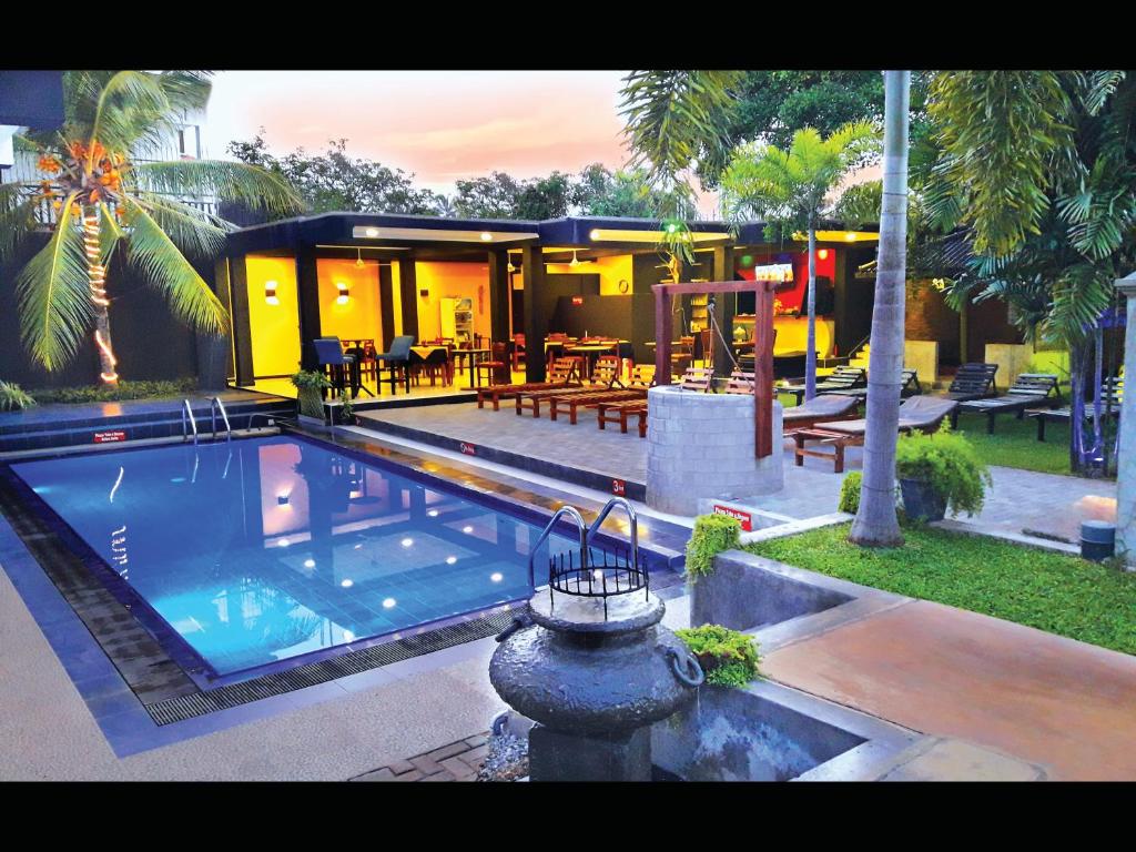 a house with a swimming pool in front of a house at The Panorama Negombo in Negombo