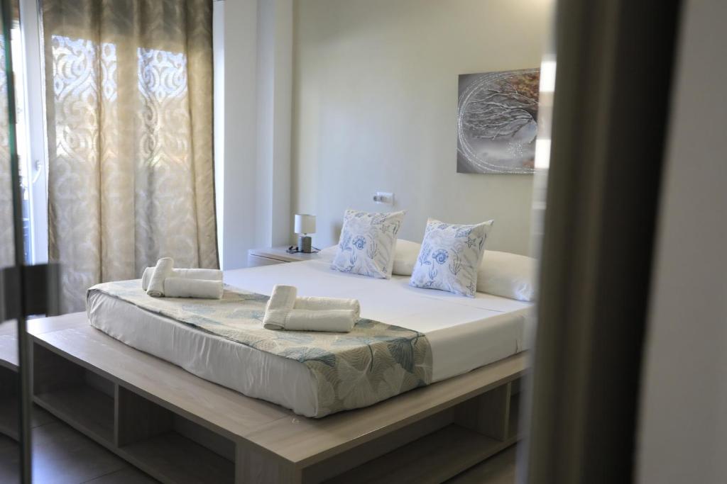 a white bed with pillows on it in a room at B&B Le Grazie Tropea in Tropea