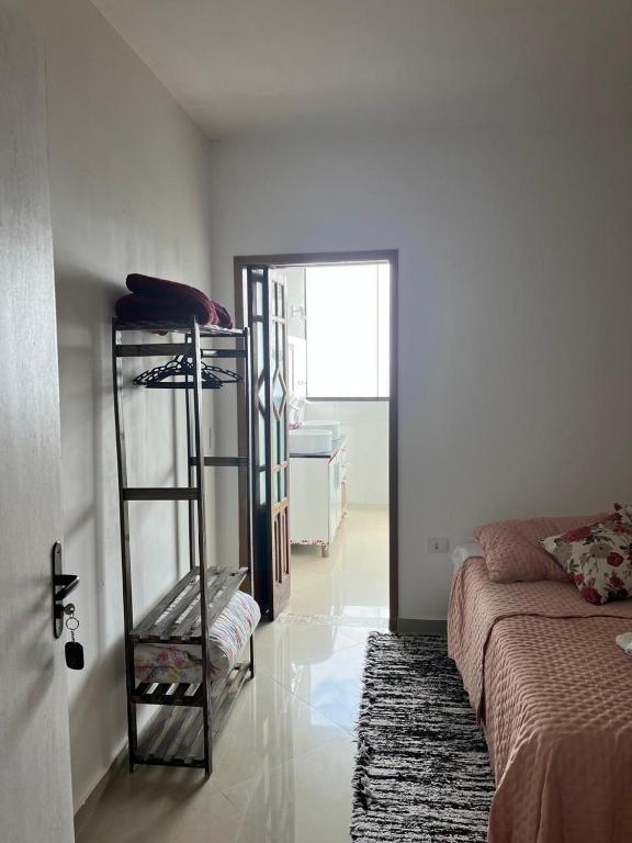 a room with a room with a bed and a ladder at CASA DE TUCA in Ilhabela
