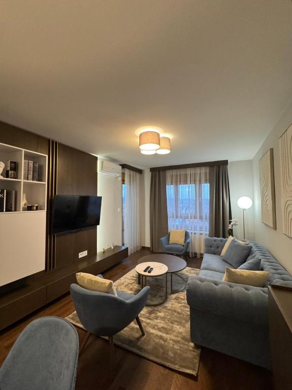 a living room with a couch and a tv at Tilia Lux apartmani in Čačak