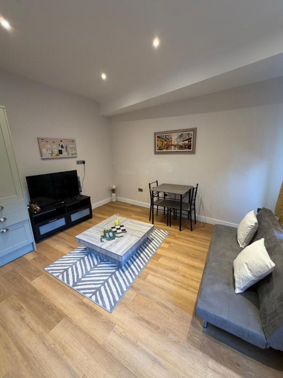 a living room with a couch and a table at Windsor Flat 90C in Windsor