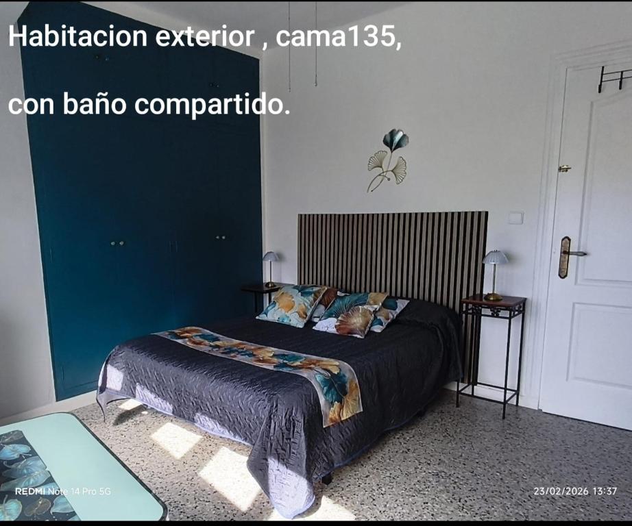 a bedroom with a bed with a blue wall at lo flamenc @Amposta in Amposta