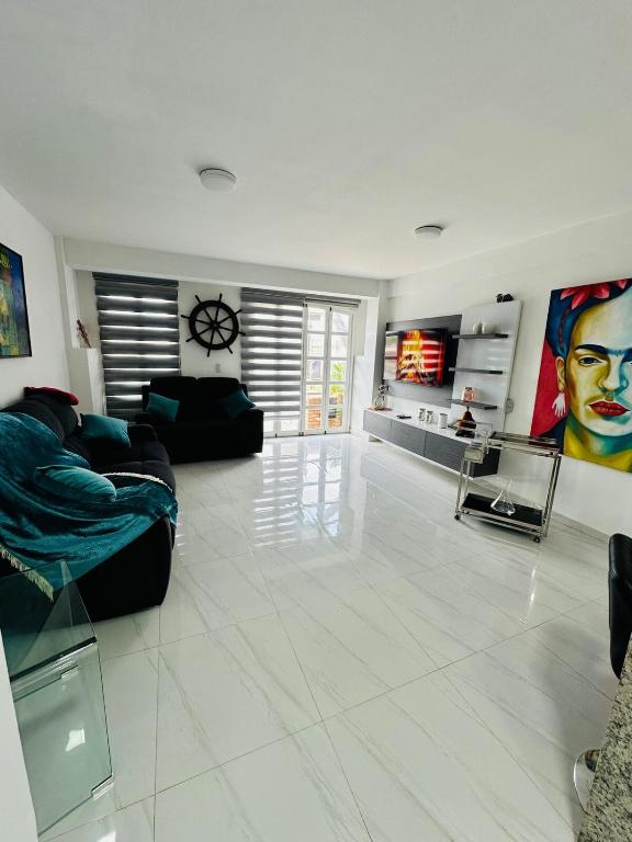 a living room with a couch and a tv at Villa Corfus in Barrio El Paraíso