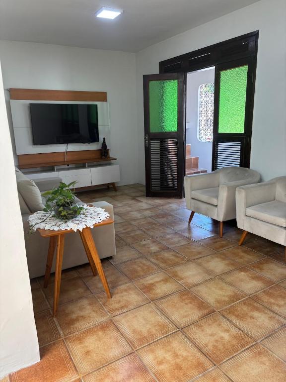 a living room with a tv and a tiled floor at Aluga-se Casa Espaçosa - 2 Quartos in São Luís