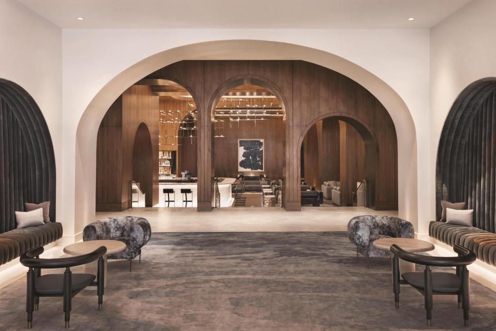 a lobby with chairs and tables in a building at Signia by Hilton San Jose in San Jose