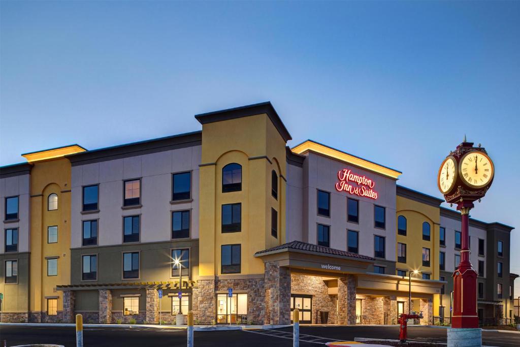 a hotel with a clock in front of a building at Hampton Inn & Suites Marina in Marina