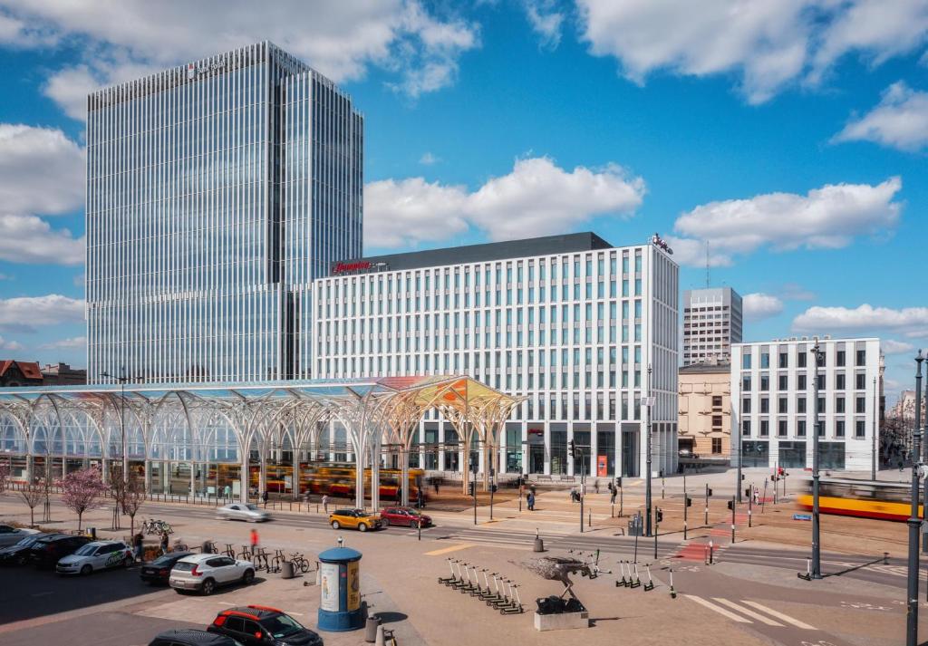 a large building with a plaza in front of it at Hampton by Hilton Łódź City Center in Łódź