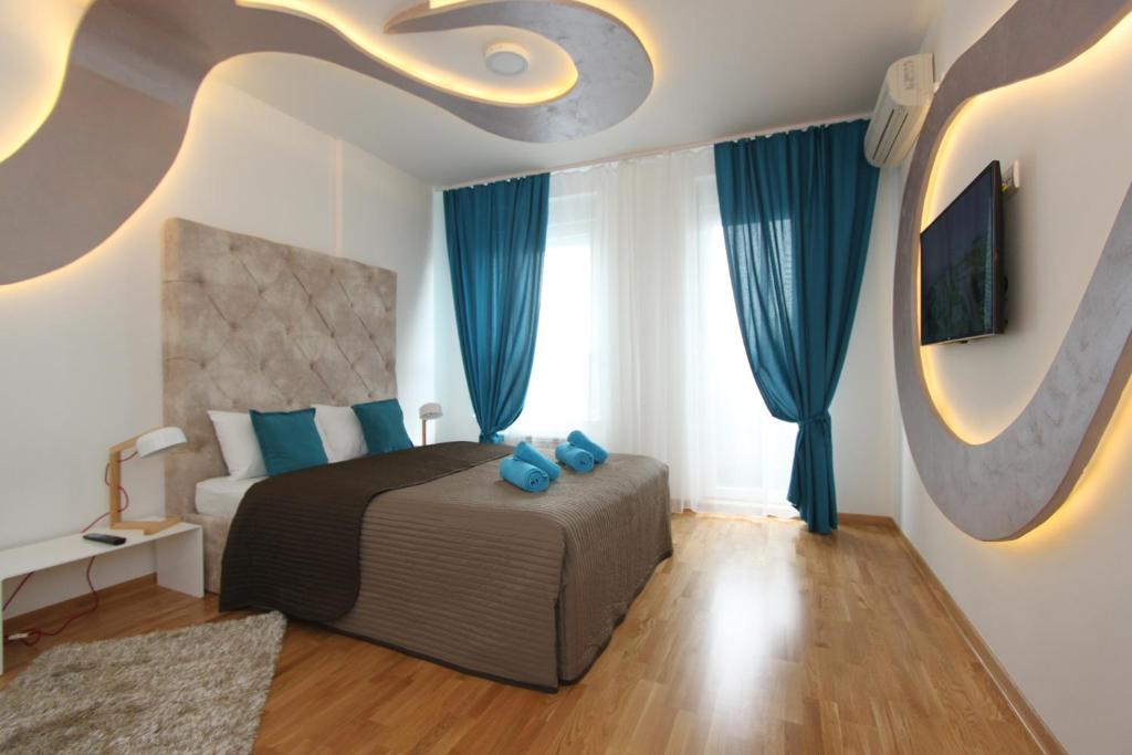 una camera da letto con letto e cuscini blu di Riviera 2 New Belgrade studio apartment, parking 5 evra dan a Belgrado