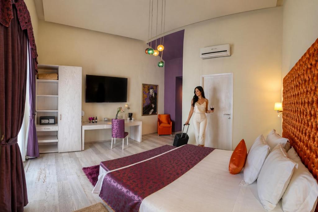 a woman is standing in a hotel room at Hotel Andante in Puebla