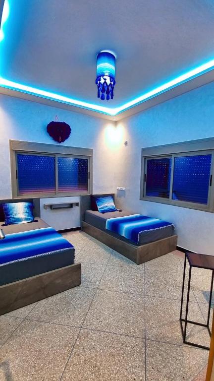 a bedroom with two beds and a blue ceiling at LH Appart 1 bel appartement cosy, vu sur montagnes, proche du lac de Bin el Ouidane et de cascades d'Ouzoud in Afourer