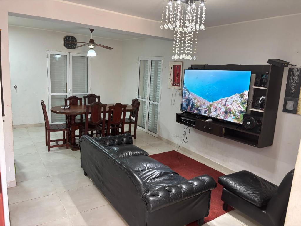 a living room with a couch and a flat screen tv at Duplex DEL CARMEN in Santiago del Estero