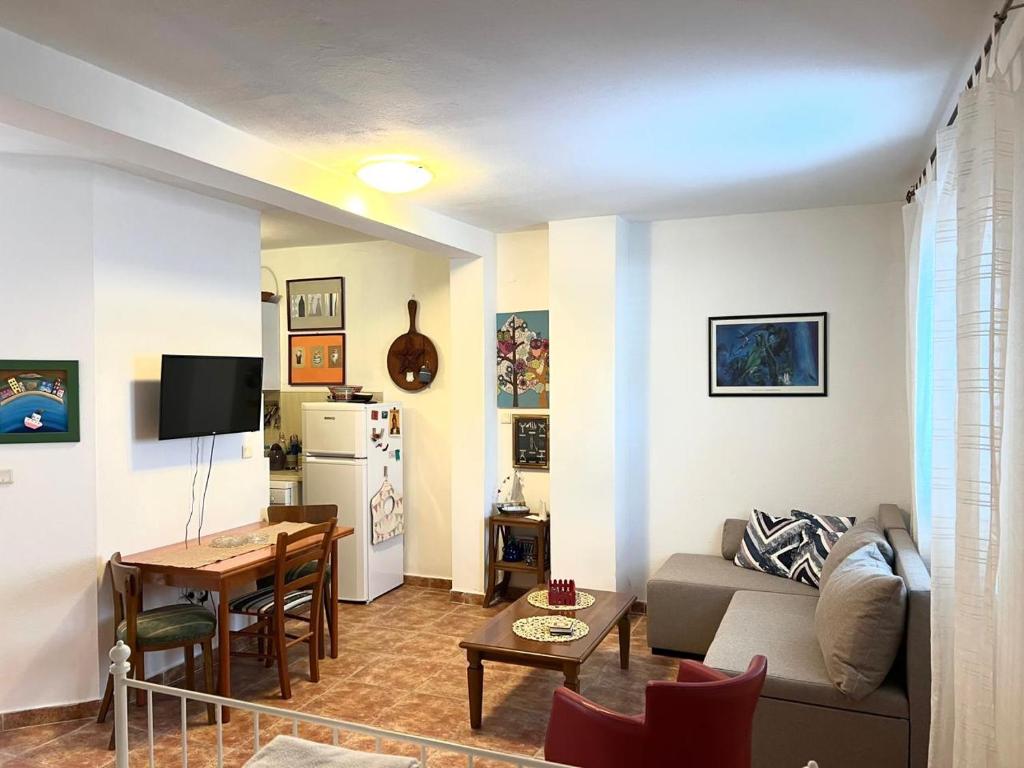 a living room with a couch and a table at Mika Studio in Tivat