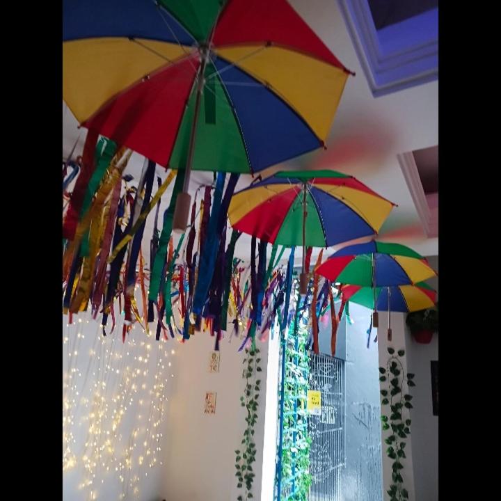 a group of colorful umbrellas hanging from a wall at Boa Viagem Inn Pousada in Recife