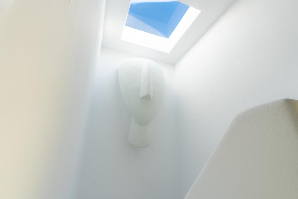 a white room with a blue window in the ceiling at Eidolion Essence - Mykonos Villa with Private Pool in Ano Mera