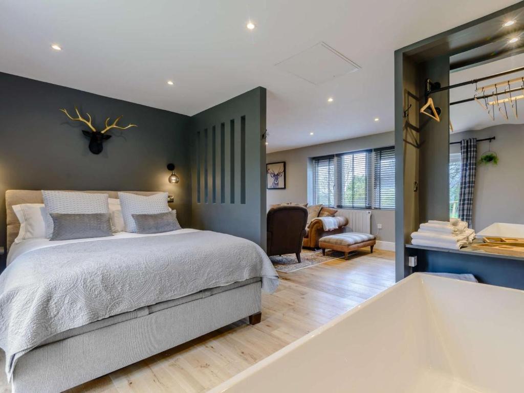 a bedroom with a large bed and a bath tub at 1 Bed in Colne oc-86513 in Rawdon
