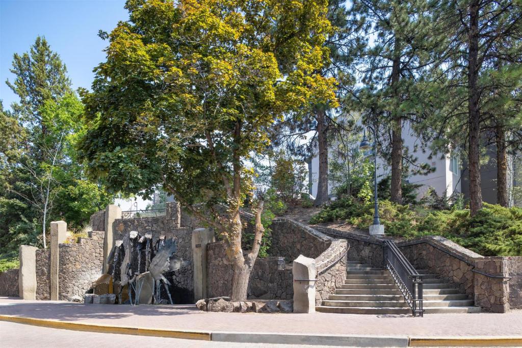 a set of stairs in a park with a fountain at The Newberry Hotel Bend, Tapestry Collection by Hilton in Bend