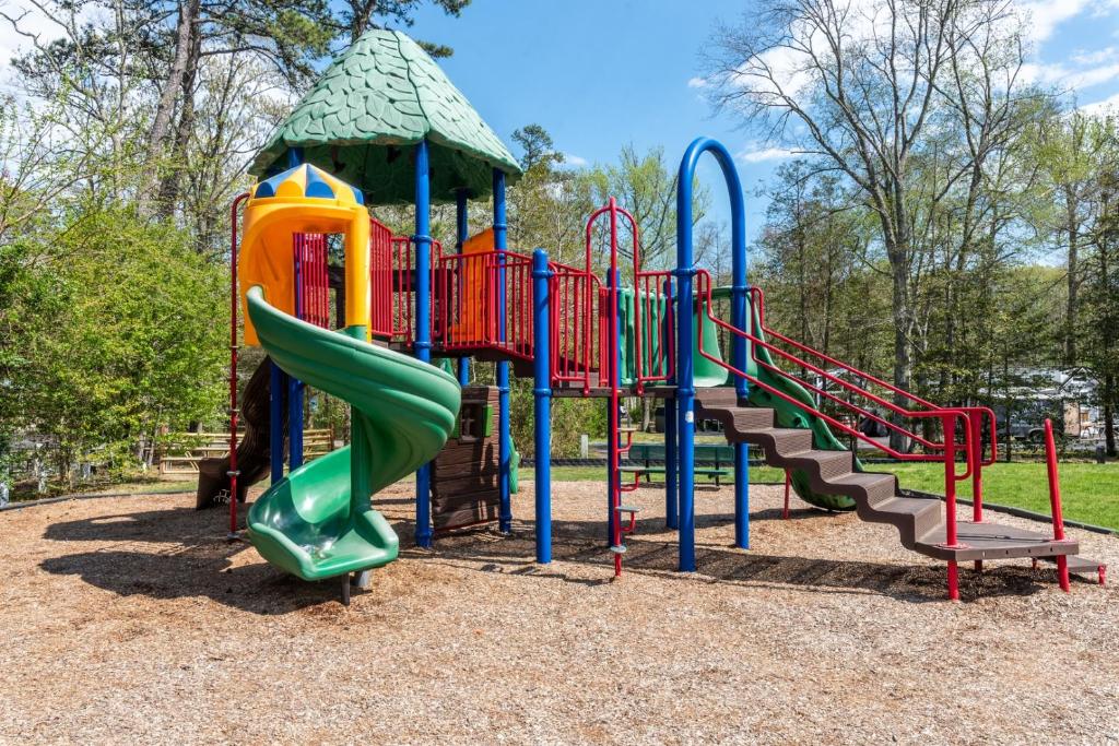 a playground with a slide and a play structure at Pool • Fire Pit • Amenities • Sleeps 8 in Swain