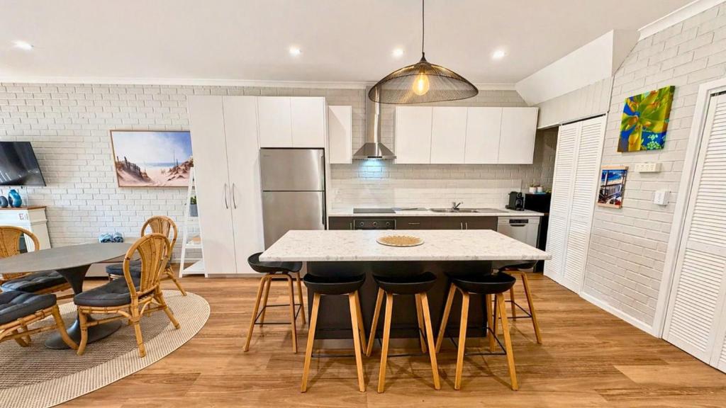 a kitchen with a table and chairs in a kitchen at Galley Cove House in Geographe