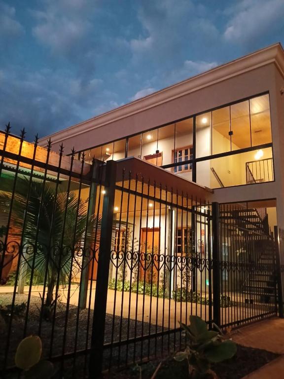 a building with a fence in front of it at Slan Ville Hotel in Chapadão do Sul