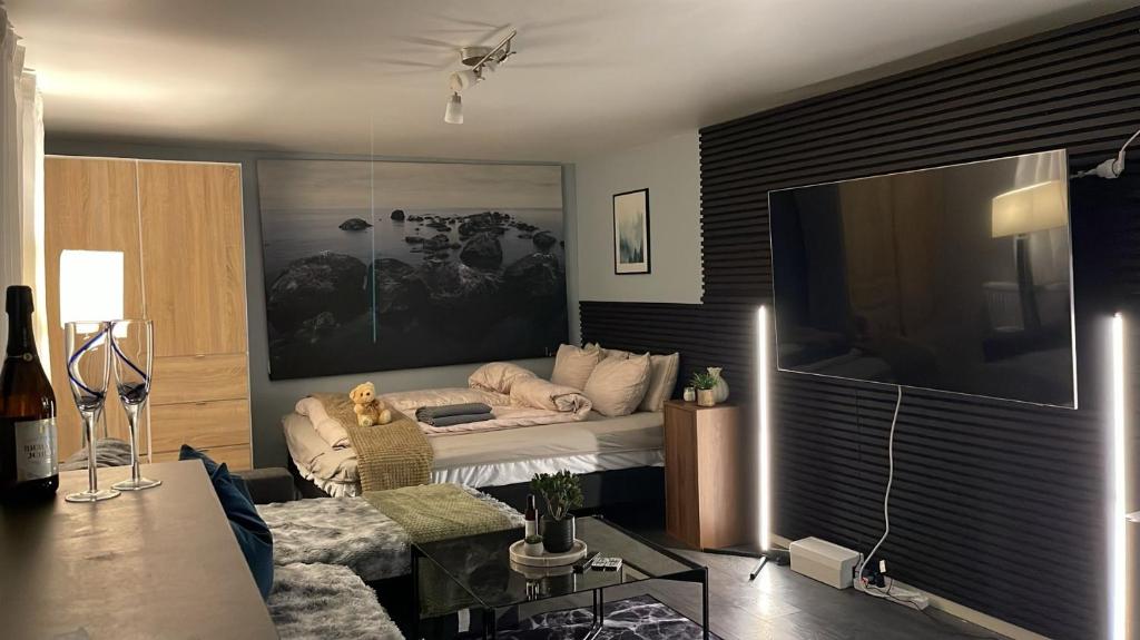 a living room with a bed and a large screen tv at Boutique apartment in Strömstad in Strömstad