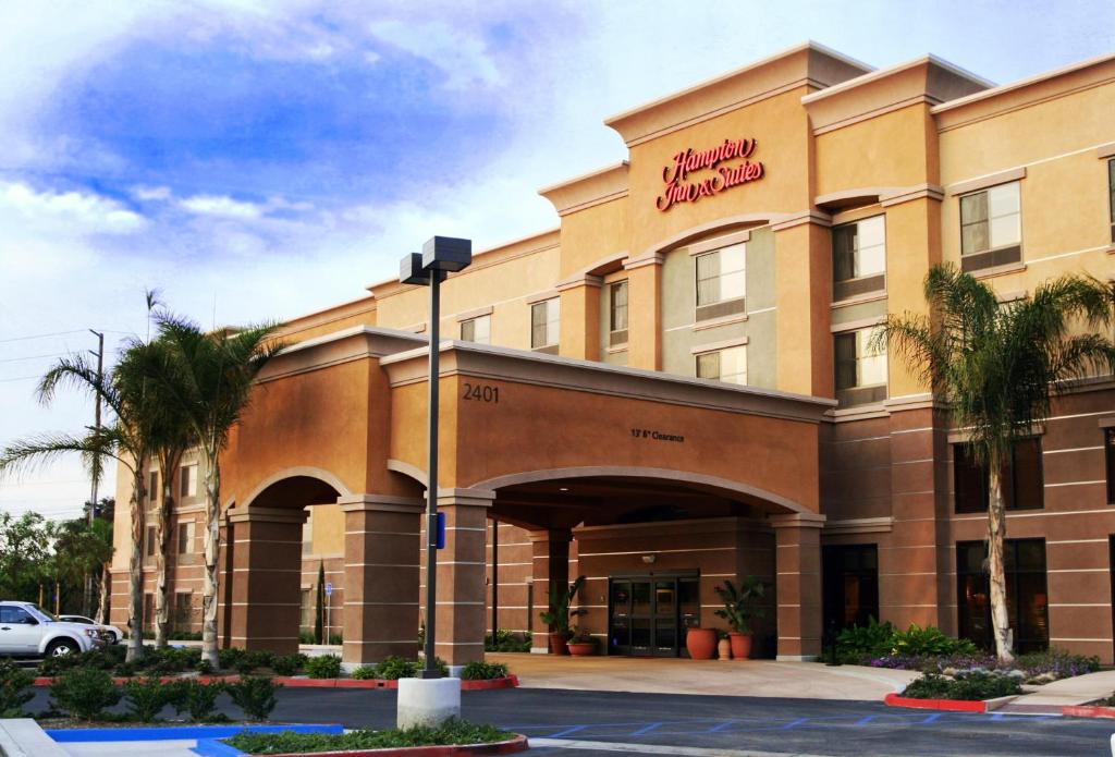 a hotel with a sign on the front of it at Hampton Inn & Suites Seal Beach in Seal Beach