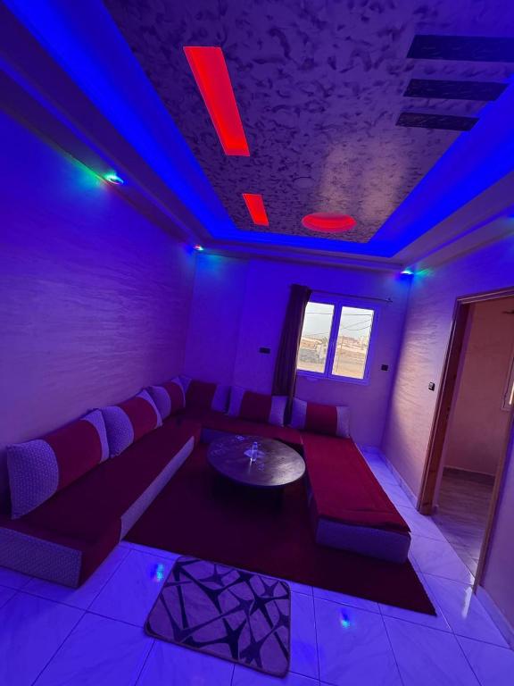 a living room with a couch and blue lights at Classico Apartments in Tan-Tan Plage