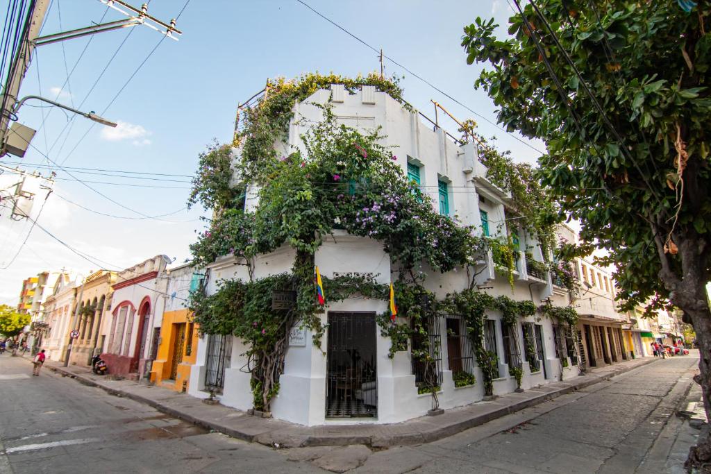 a white building with flowers on it on a street at Casa La Bella Samaria Boutique in Santa Marta