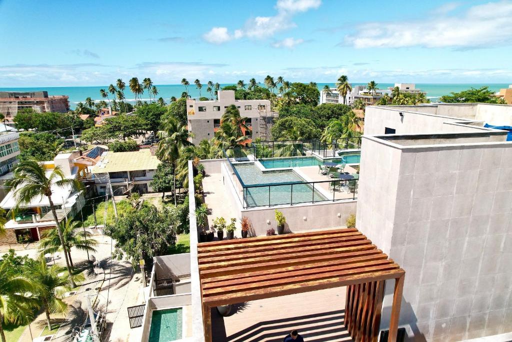 a view of the city from the balcony of a building at Sofisticado 2Q 200m do Mar 1 min do Centrinho in Porto De Galinhas