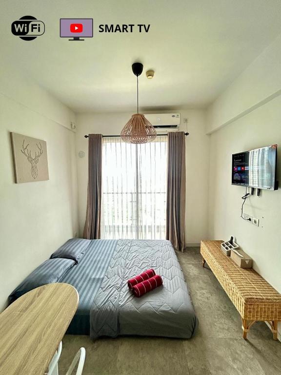 a bedroom with a large bed and a window at Kawoeng skyhouse BSD in Cilenggang