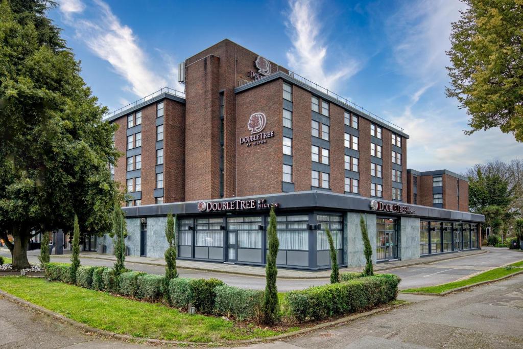 a building with a sign on the front of it at DoubleTree by Hilton London Ealing in London