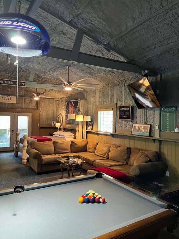 a living room with a pool table in front of it at Cozy Barn with Pool Access & Near Lake Conroe in Montgomery