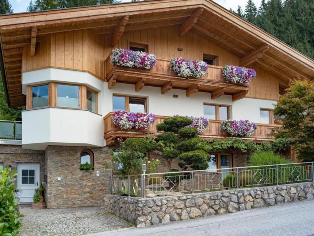 a house with flowers on the balcony of it at Apartment Gartentraum in Itter