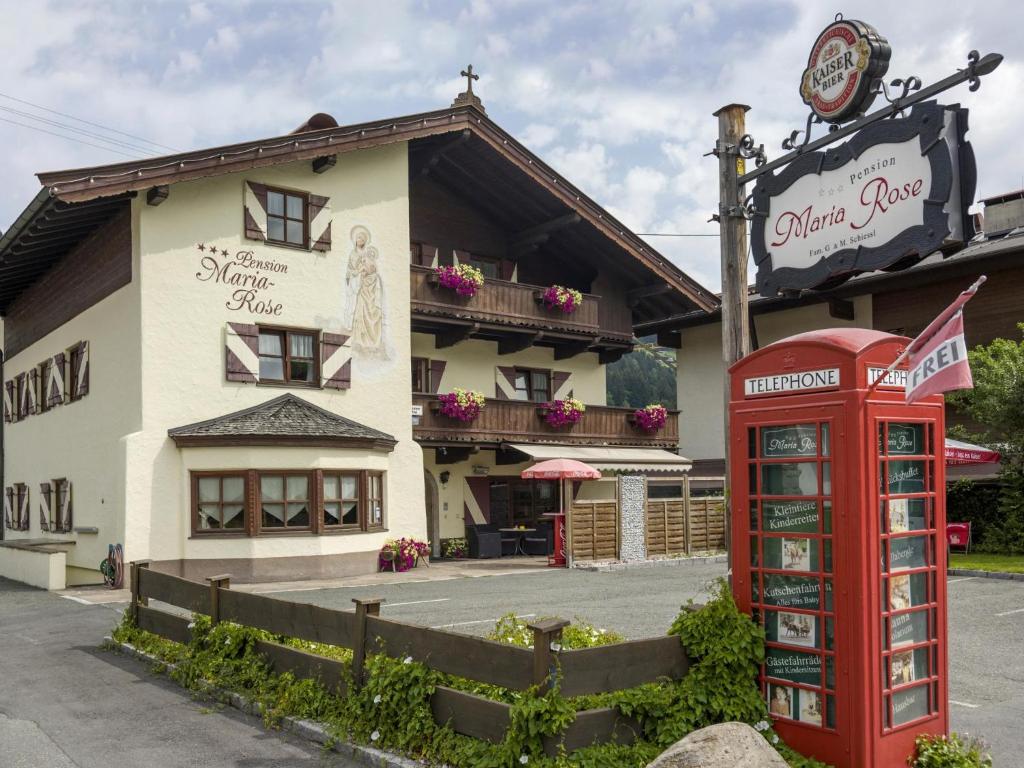 a red telephone booth in front of a building at Maria Rose XXL in Kirchberg in Tirol