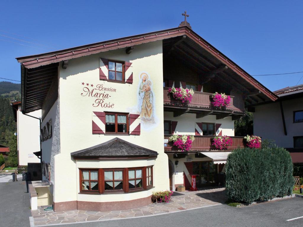 a building with a sign on the side of it at Maria Rose XL in Kirchberg in Tirol