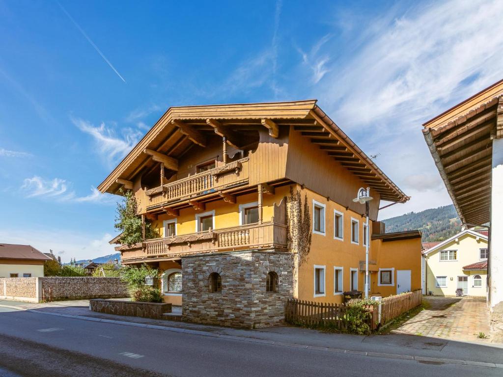 a house with a balcony on the side of a street at Pension Schreder XL in Kirchberg in Tirol