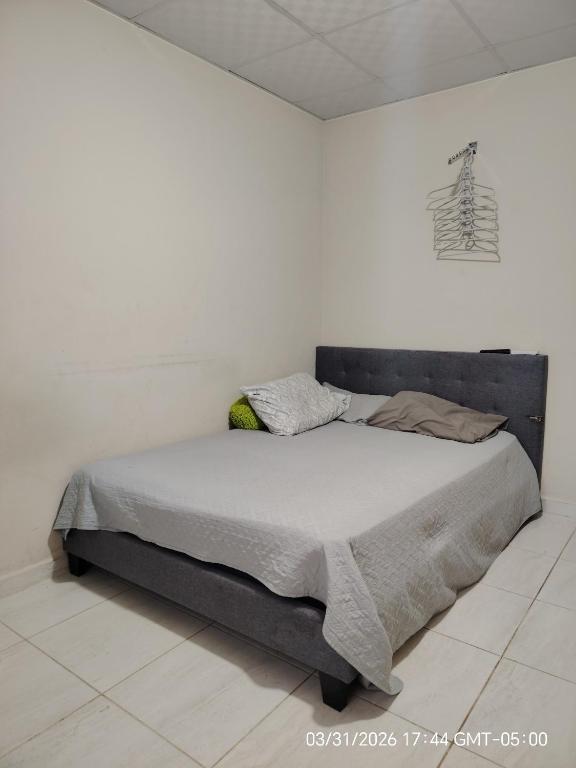 a bed in a white room with a white wall at Jadash house in David