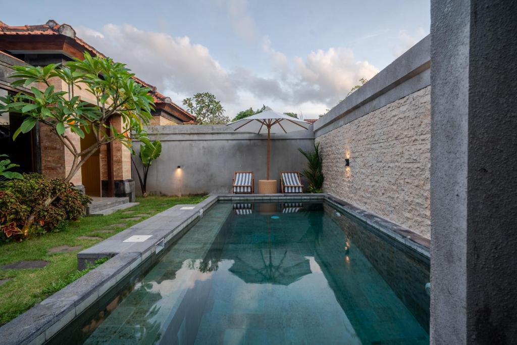 a swimming pool in the backyard of a house at Maheeka Villa, Sanur in Sanur