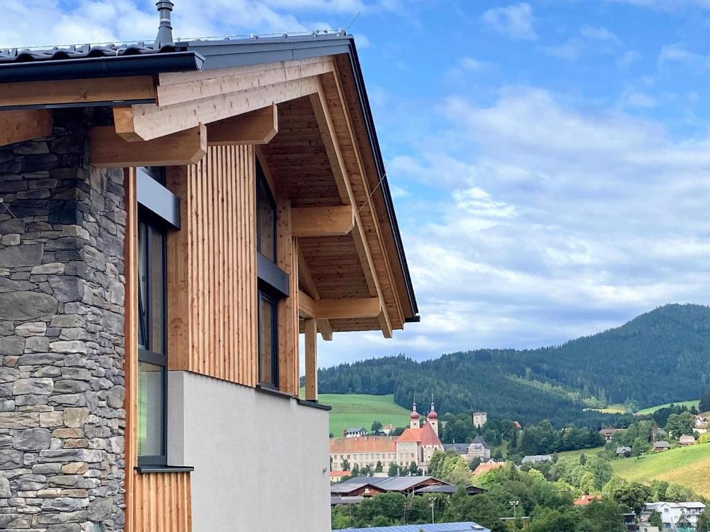 a balcony of a building with a view of a town at Grebenzen Lodge 1028 in Sankt Lambrecht