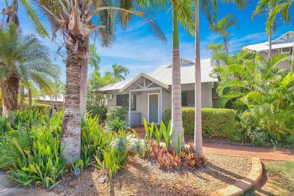 a house with palm trees in front of it at Pearl Escape in Broome