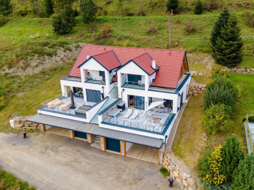 an aerial view of a house with a red roof at Doppellodge in Sankt Lorenzen ob Murau