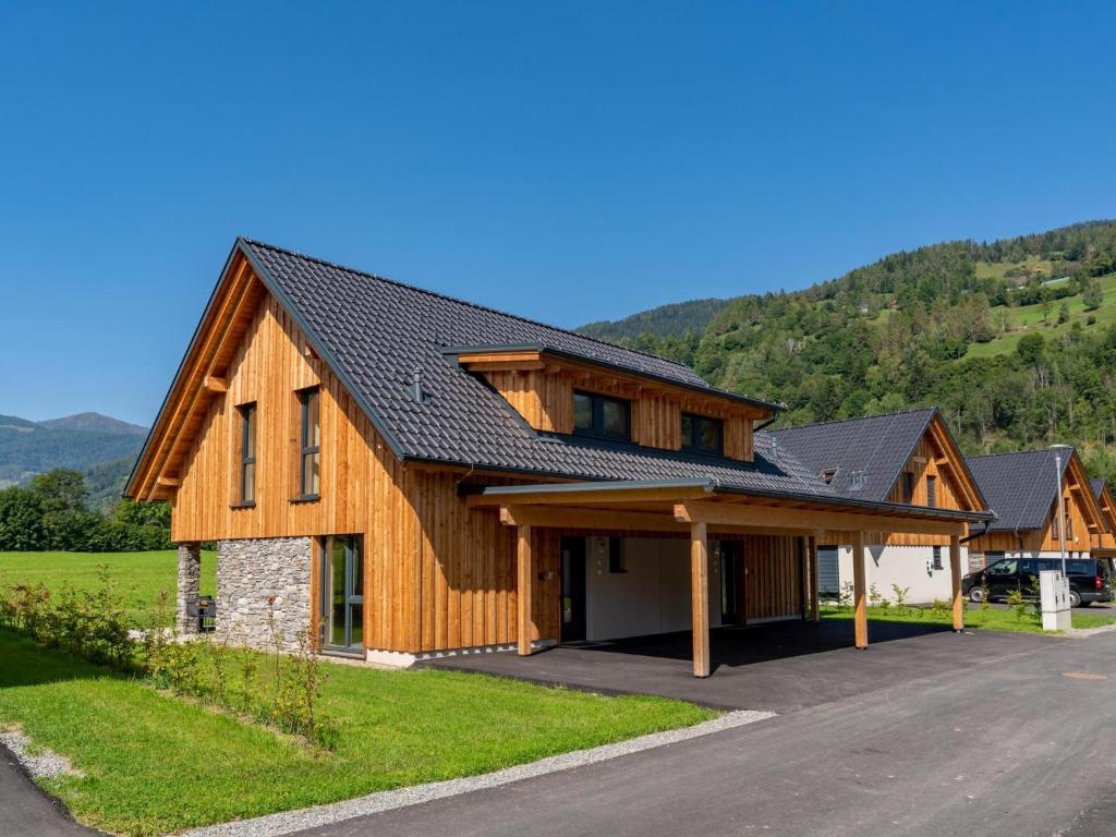 a wooden house with a gambrel roof at Mountain Chalet Aquarius 5A in Sankt Lorenzen ob Murau