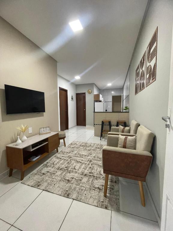 a living room with a couch and a tv at Apto do xavier III in Petrolina