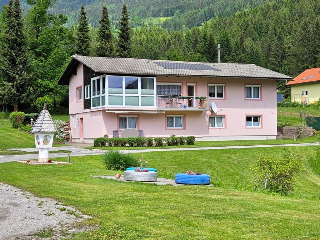 a pink house with a gazebo at Mangartblick in Arriach