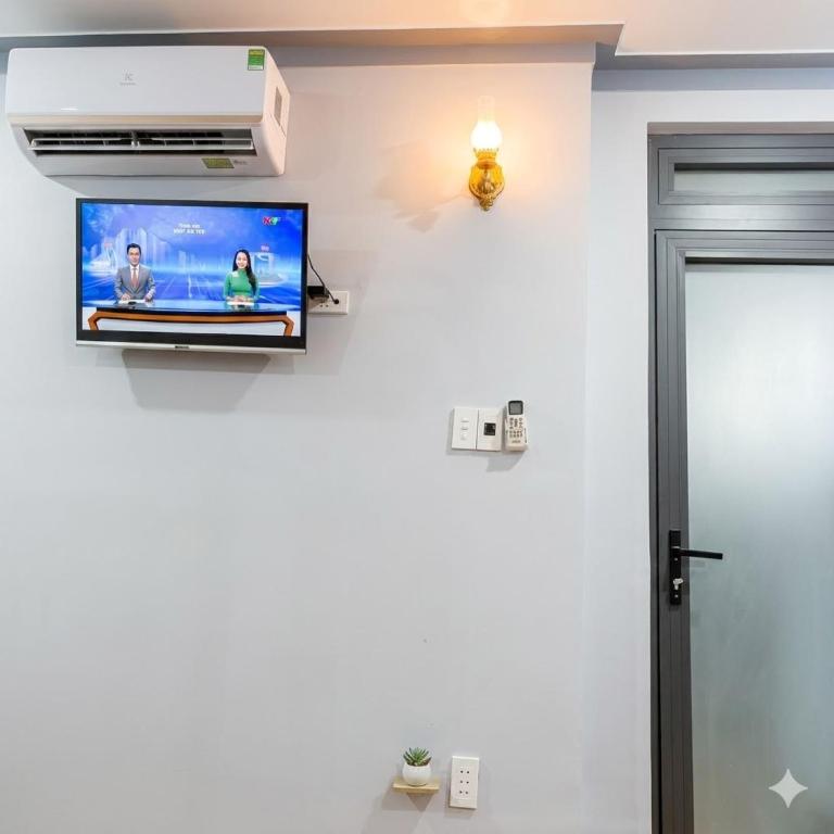 a television on a wall in a room at Du mục stay in Ninh Hải