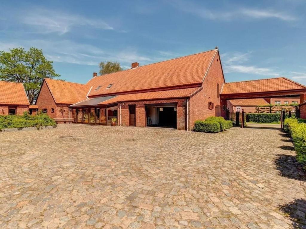 a large brick building with a large driveway at De Marckhoeve in Merksplas