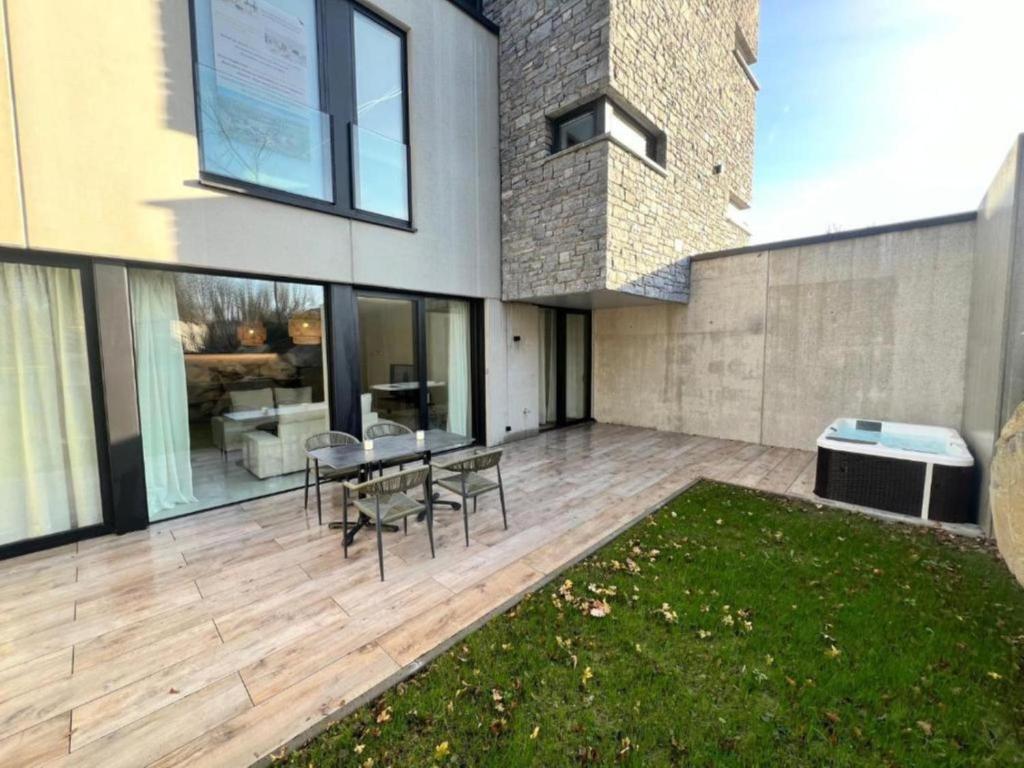 a patio with a table and chairs in a house at Be Durbuy in Durbuy