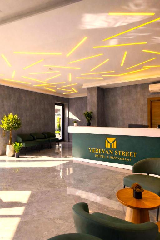 a lobby with couches and tables in a building at Yerevan Street hotel in Yerevan