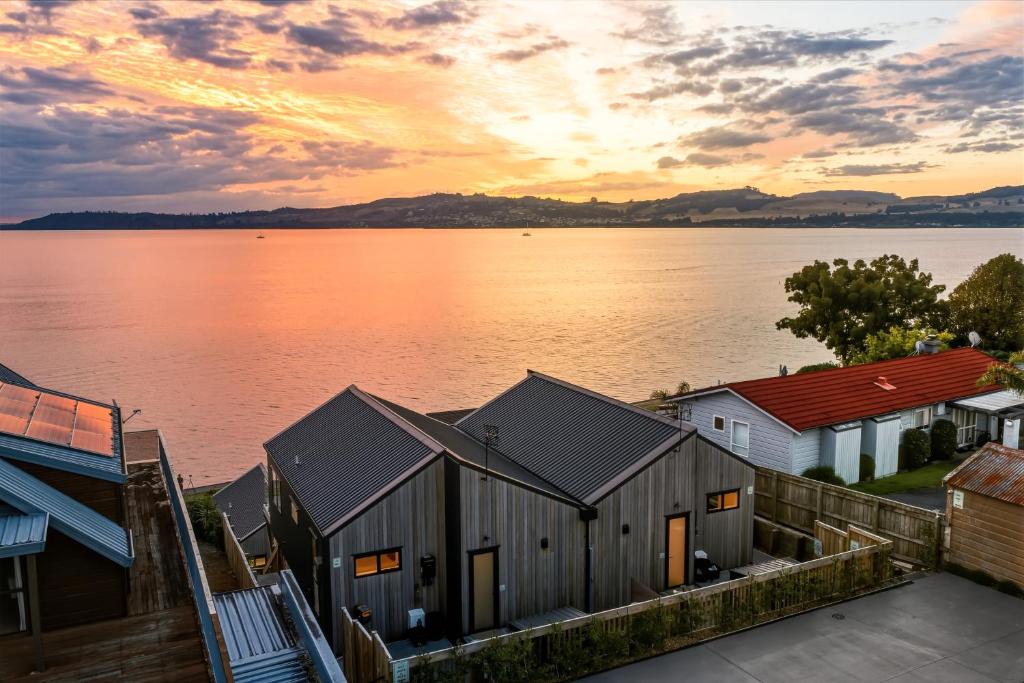 a view of a body of water with houses at Roam Taupo Lakefront Combined Units 3&4 in Taupo